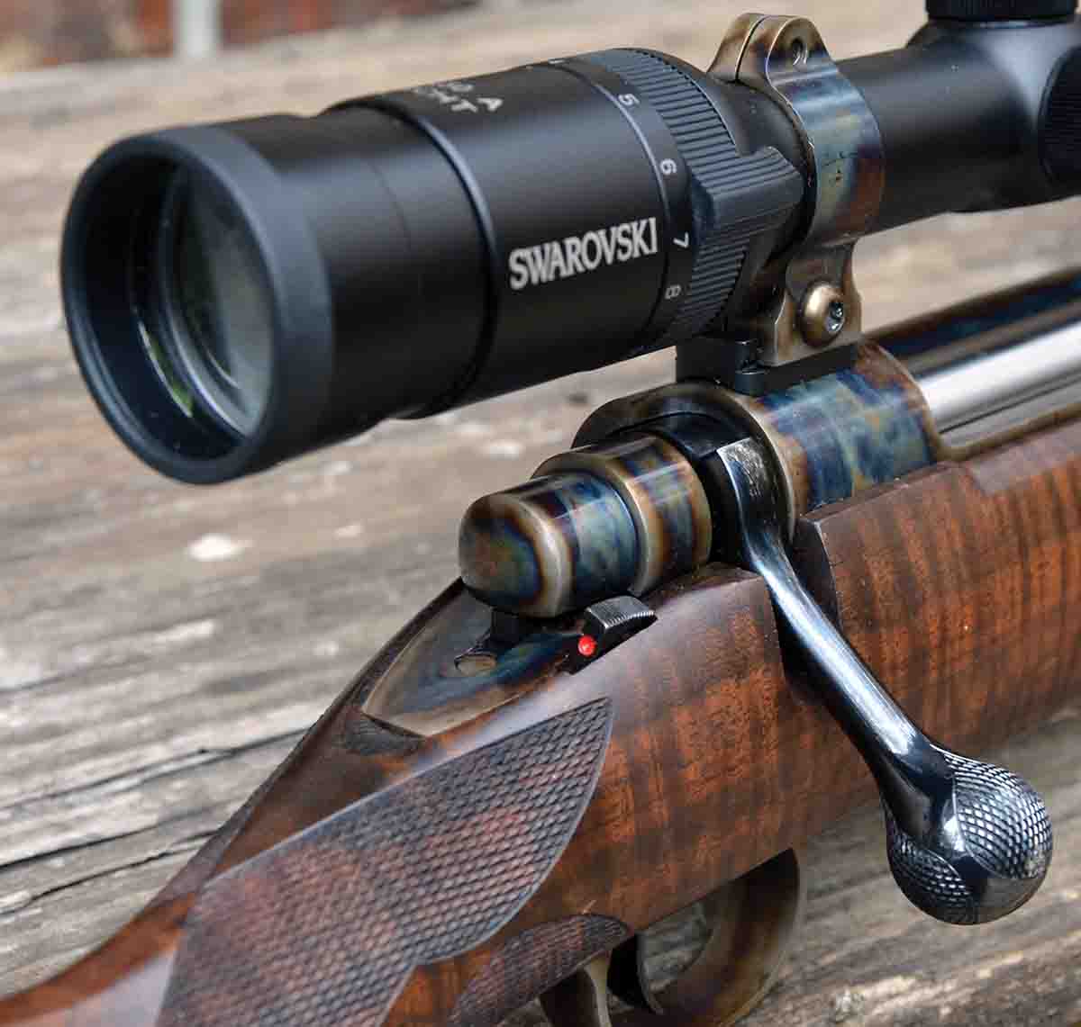 Case-coloring on the bolt shroud and rings and three-panel checkering on the bolt-handle knob make for a handsome hunting rifle.